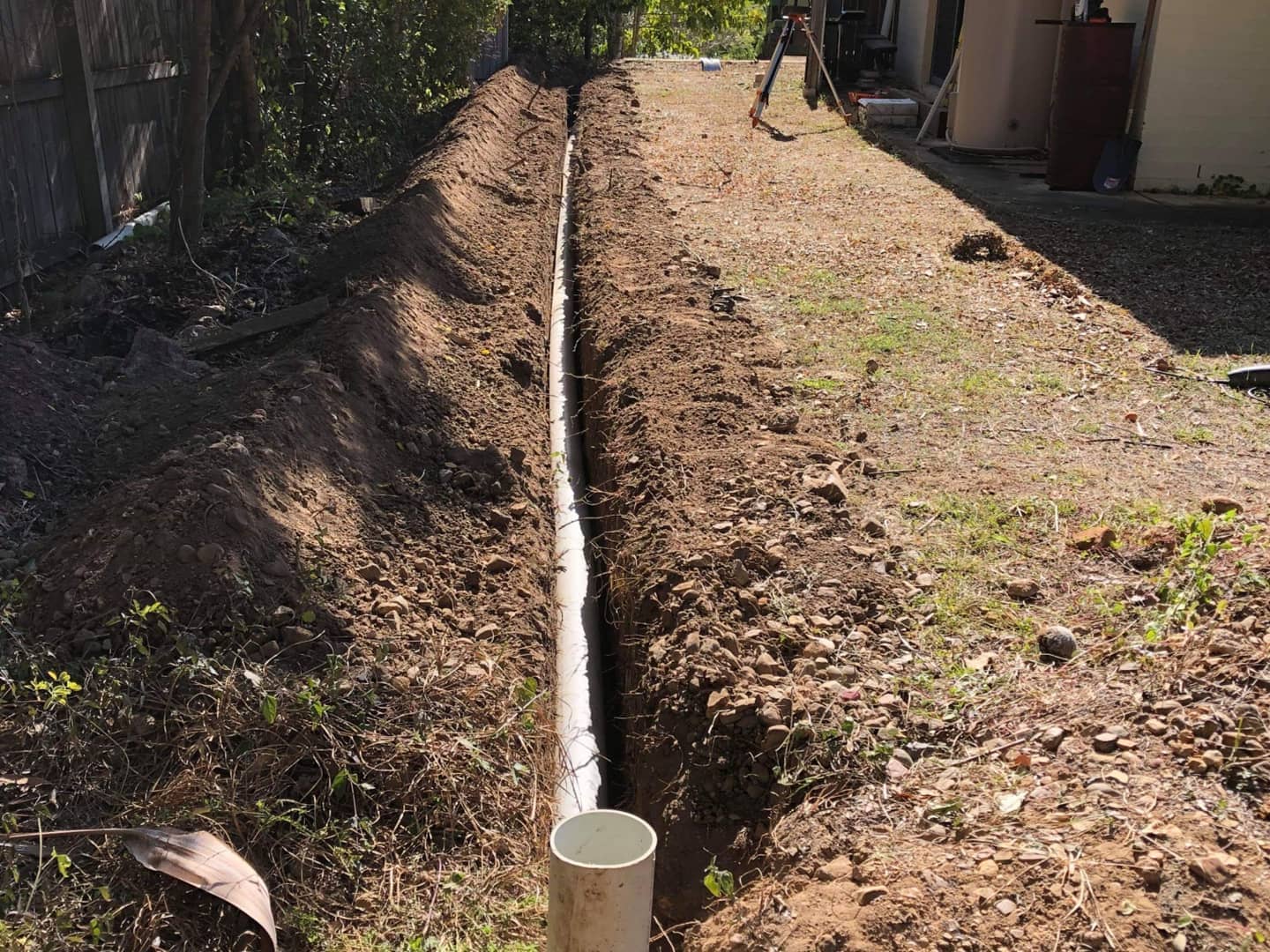 All the water flowed off this tennis court down to the back patio covering it in water every time. We installed drainage along the entire length of the tennis court and out to the street. No more wet patio.Call 0468477937 @ Bellbowrie