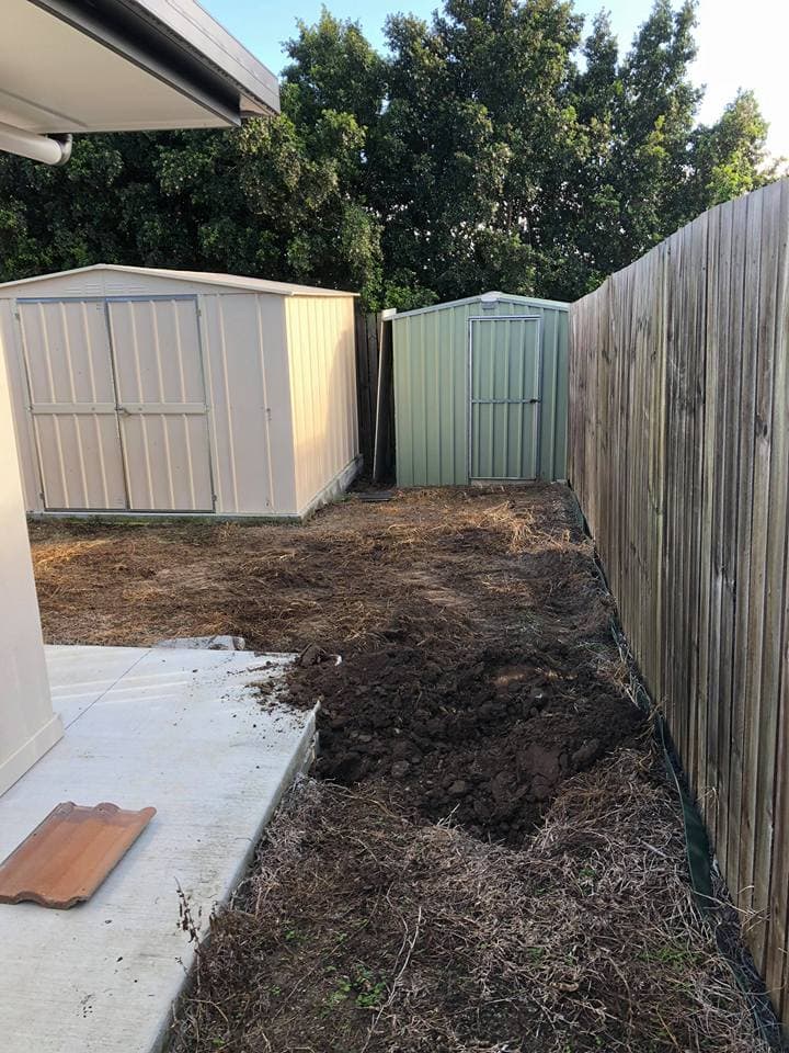 Ian Rogers hard at work and still smiling cleared out the whole backyard ready for some landscape renovations