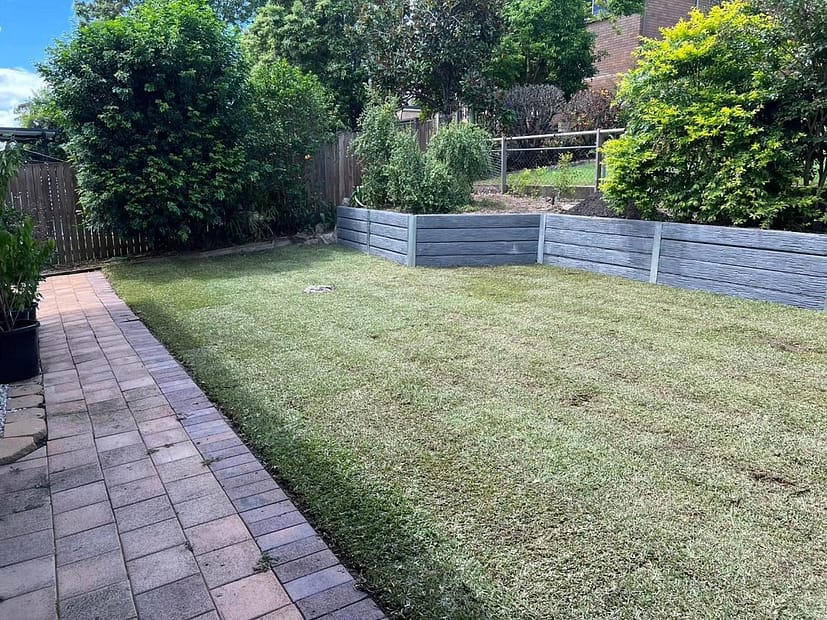 Concrete sleeper retaining wall, garden bed and turfing