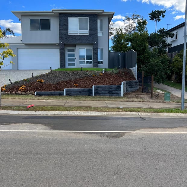 Concrete sleeper retaining wall built around a sewer manhole 1