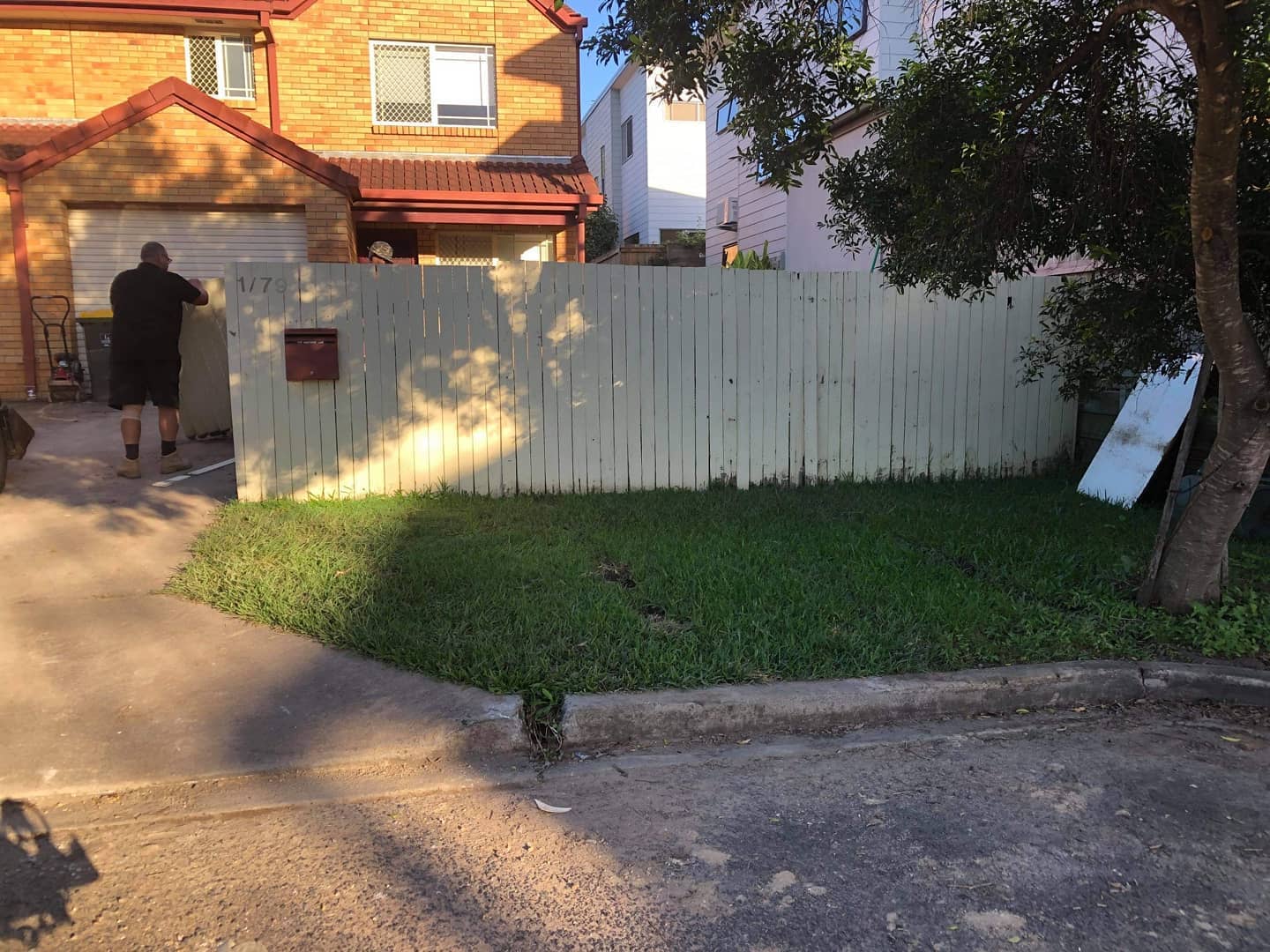 Timber fence concrete entrance stepping stones and front grass