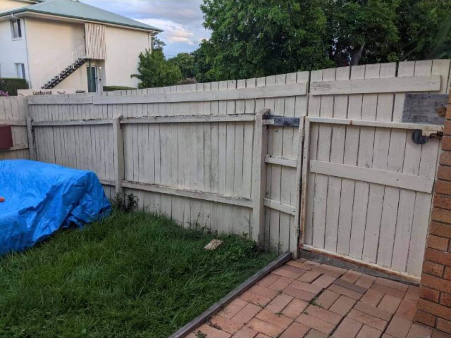 Timber fence concrete entrance stepping stones and front grass