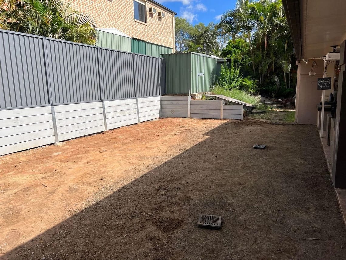 Large dig out, concrete retaining wall and colourbond fencing