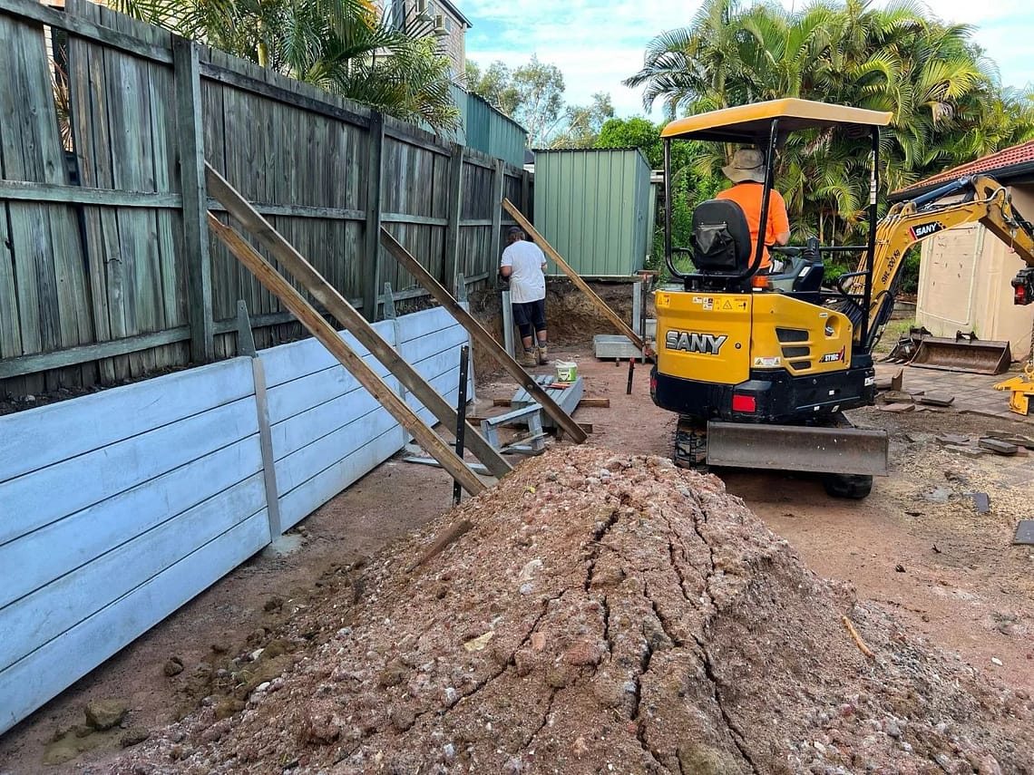 Large dig-out, concrete retaining wall and colourbond fencing