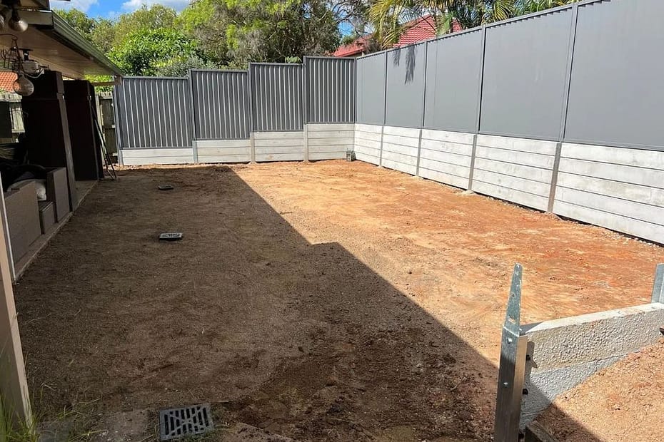 Large dig out, concrete retaining wall and colourbond fencing